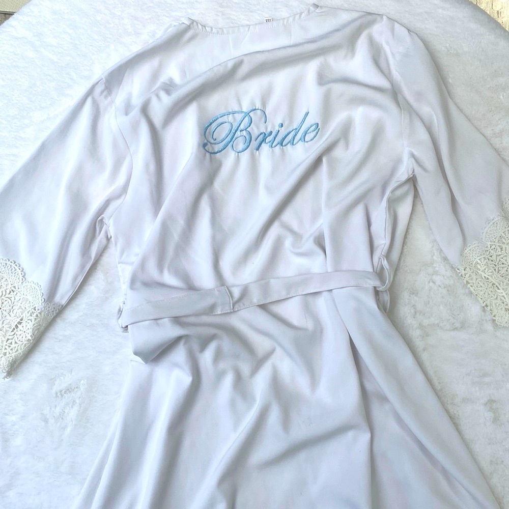 Embroidered bride robe in white with blue lettering and lace detail on arm